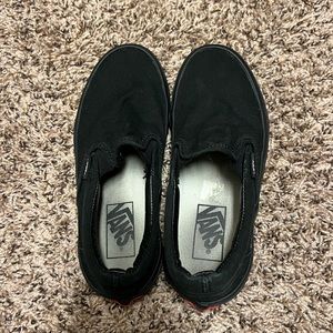 All black slip on vans